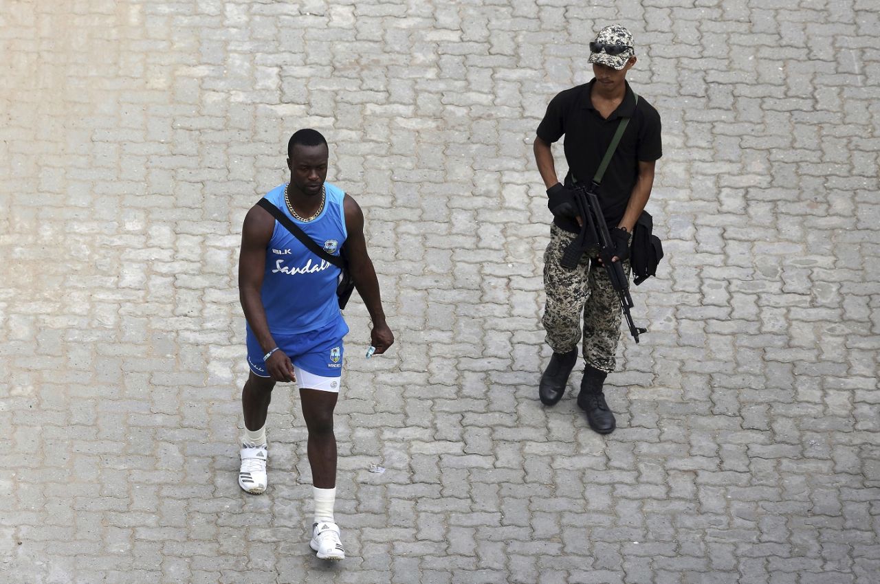 Kemar Roach is escorted by a security officer, October 20, 2018, Guwahati