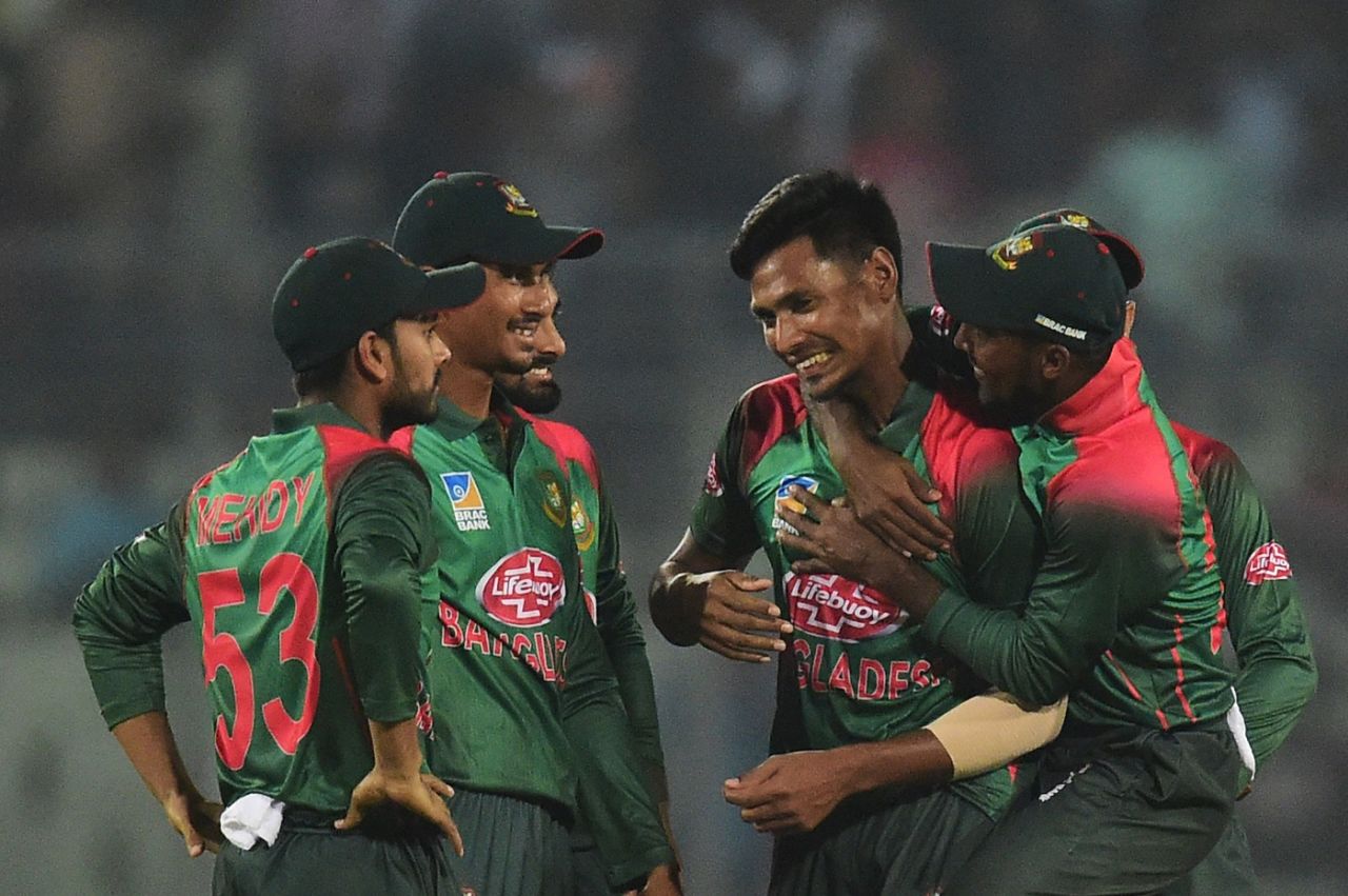 Mustafizur Rahman is congratulated by his team-mates, Bangladesh v Zimbabwe, 1st ODI, Mirpur, October 21, 2018