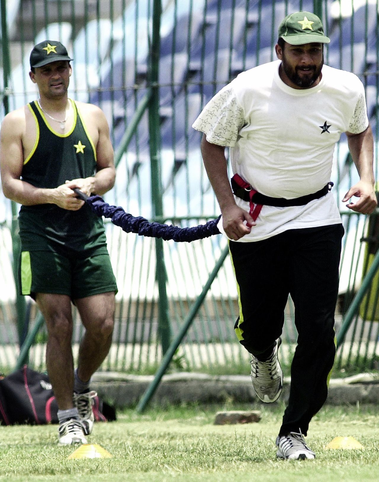 Inzamam-ul-Haq does resistance training with a rope tied around him and held by team-mate Moin Khan, Lahore, July 5, 2004