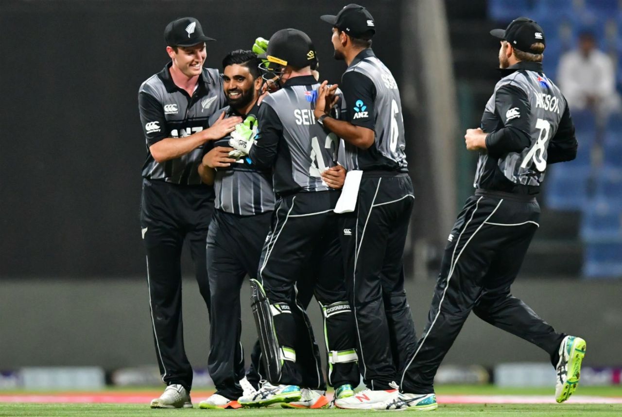 Ajaz Patel is mobbed by teammates after snaring his maiden international wicket, Pakistan v New Zealand, 1st T20I, Abu Dhabi, October 31, 2018