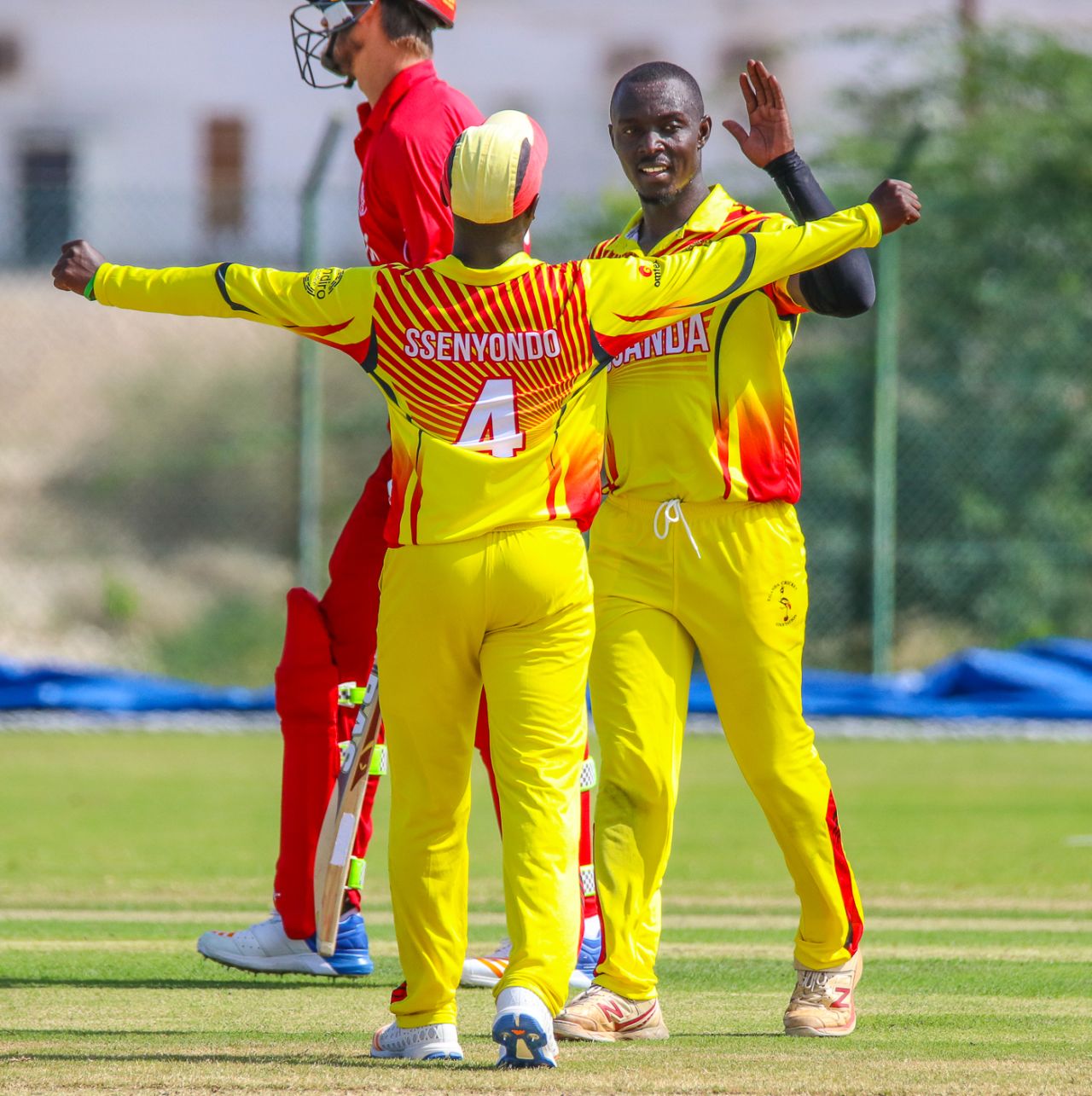 Charles Waiswa gets some love from Henry Ssenyondo after wiping out the tail with 4 for 25, Denmark v Uganda, ICC World Cricket League Division Three, Al Amerat, November 9, 2018