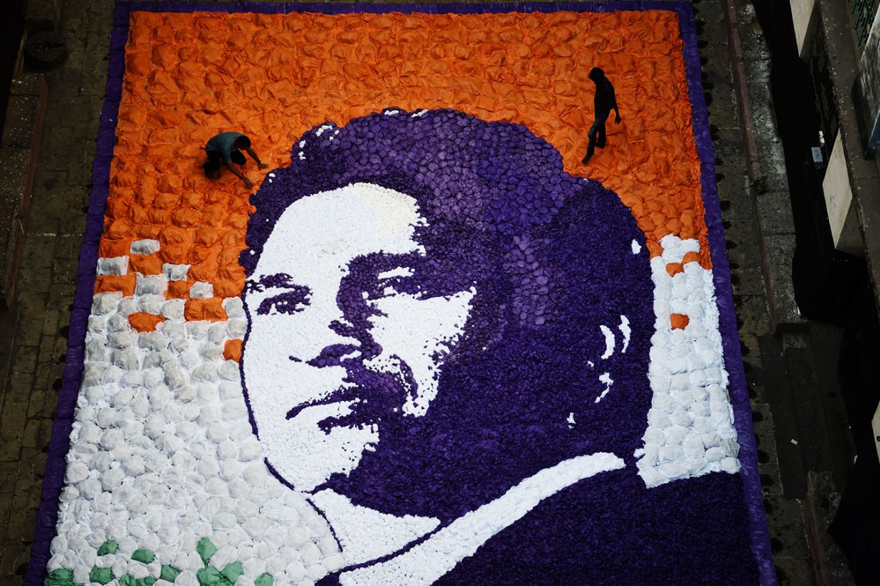Artists complete a portrait of Sachin Tendulkar made with pieces of paper for his 45th birthday, Mumbai, April 24, 2018