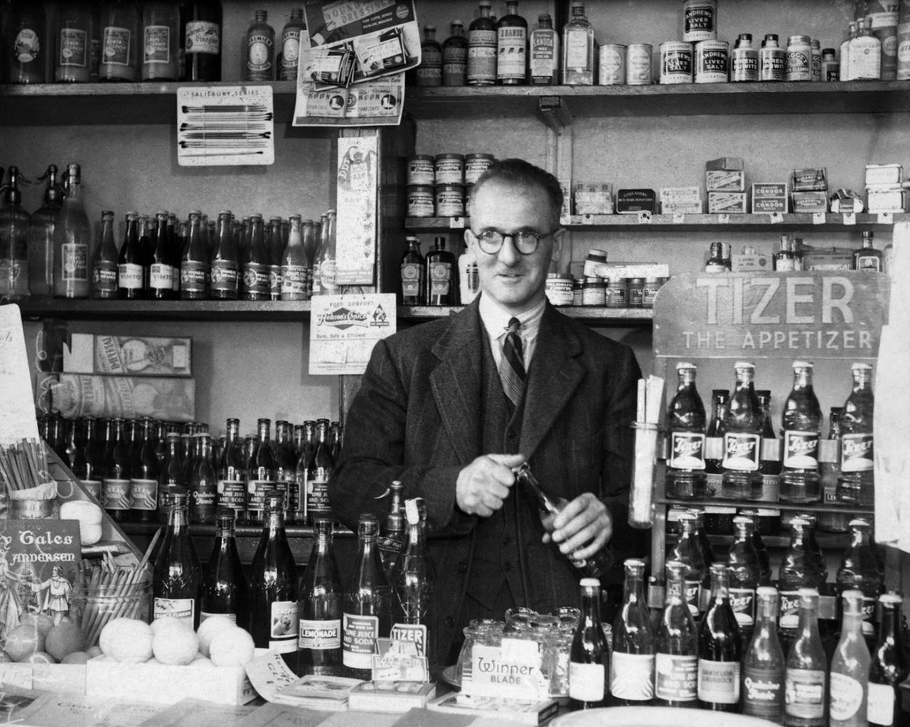 Harold Larwood behind the counter of his sweet shop in Caunce Street, Blackpool, England, August 2, 1949