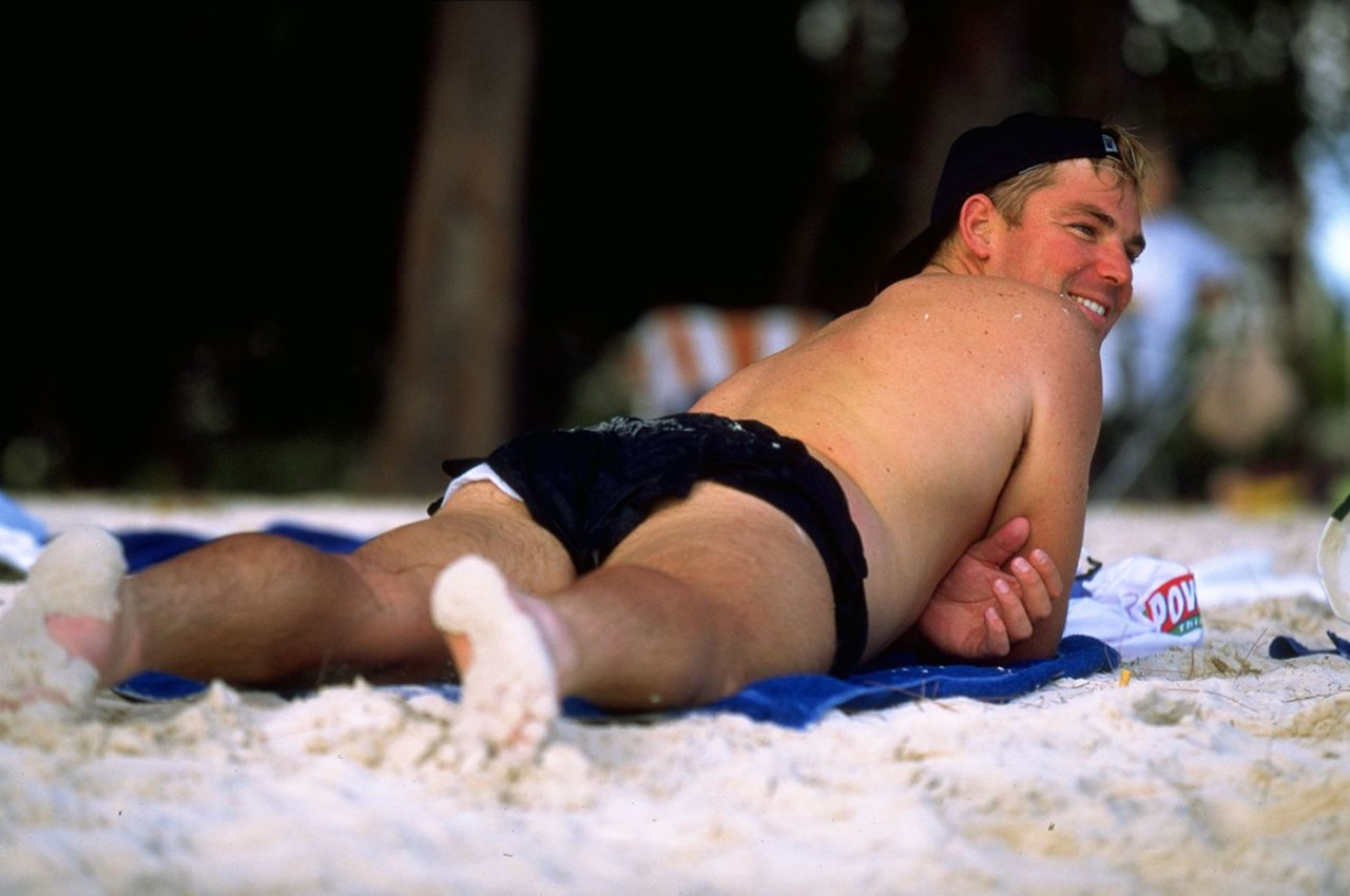 Shane Warne relaxes on a beach, March 1995