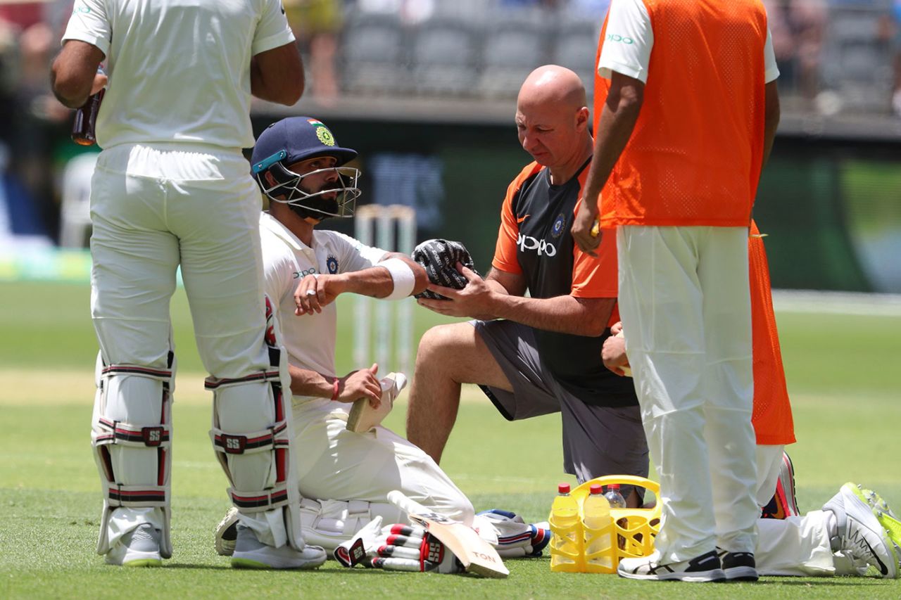 Virat Kohli gets some treatment after a blow from Mitchell Starc, Australia v India, 2nd Test, Perth, December 16, 2018