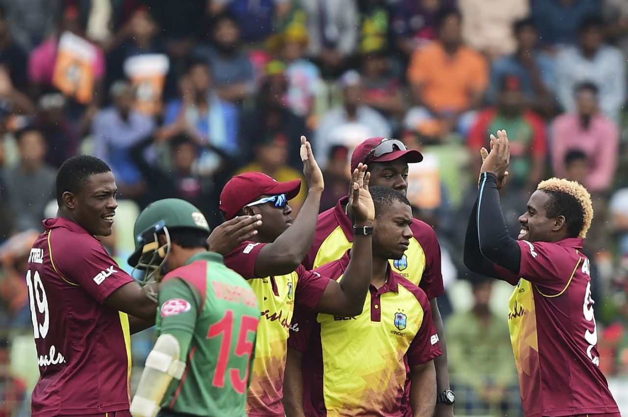 Mushfiqur Rahim walks back as the West Indian players celebrate Rovman Powell's direct-hit, Bangladesh v West Indies, 1st T20I, Sylhet, December 17, 2018