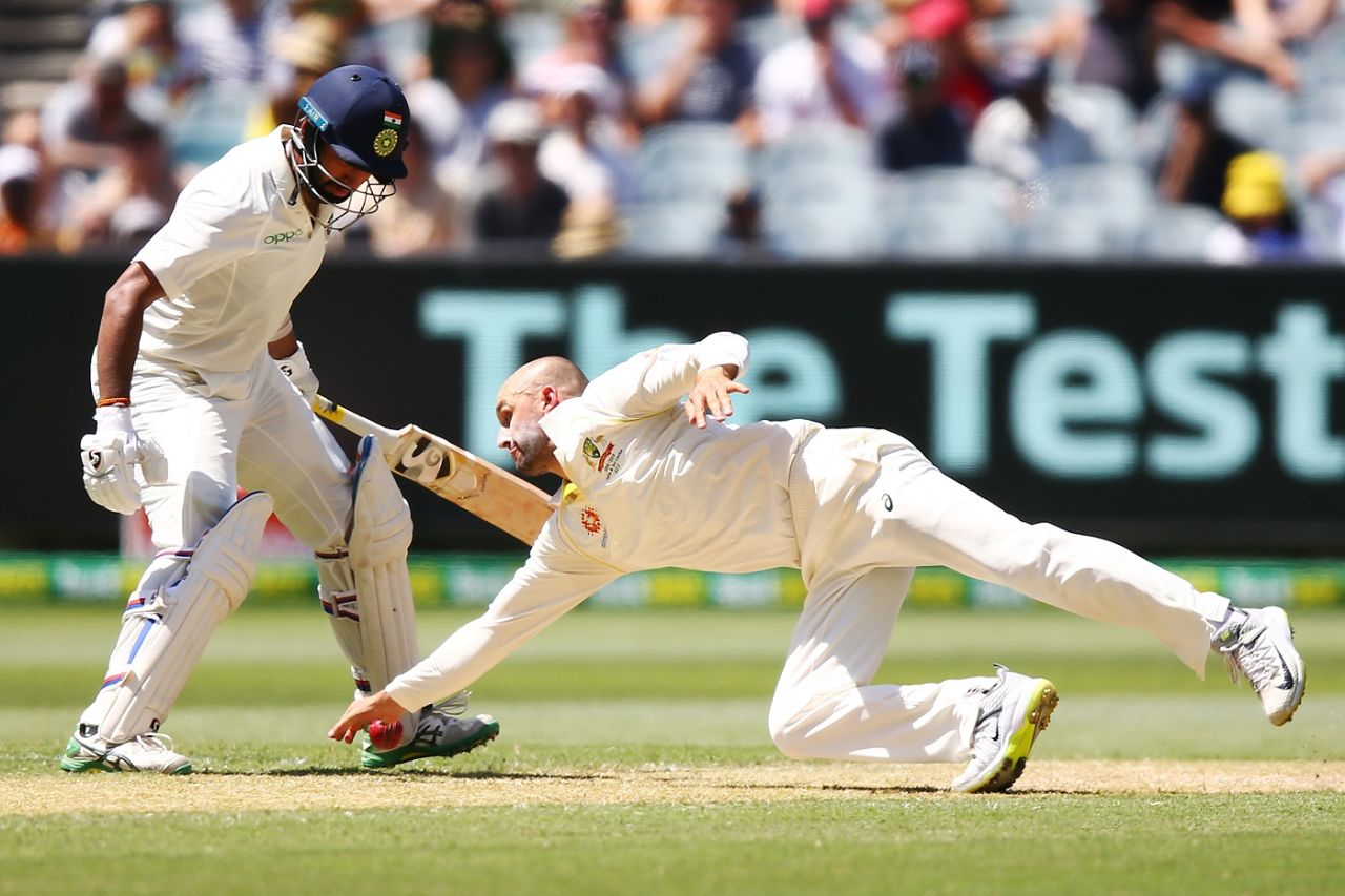 Nathan Lyon reaches out for the ball off his own bowling, Australia v India, 3rd Test, Melbourne, 2nd day, December 27, 2018