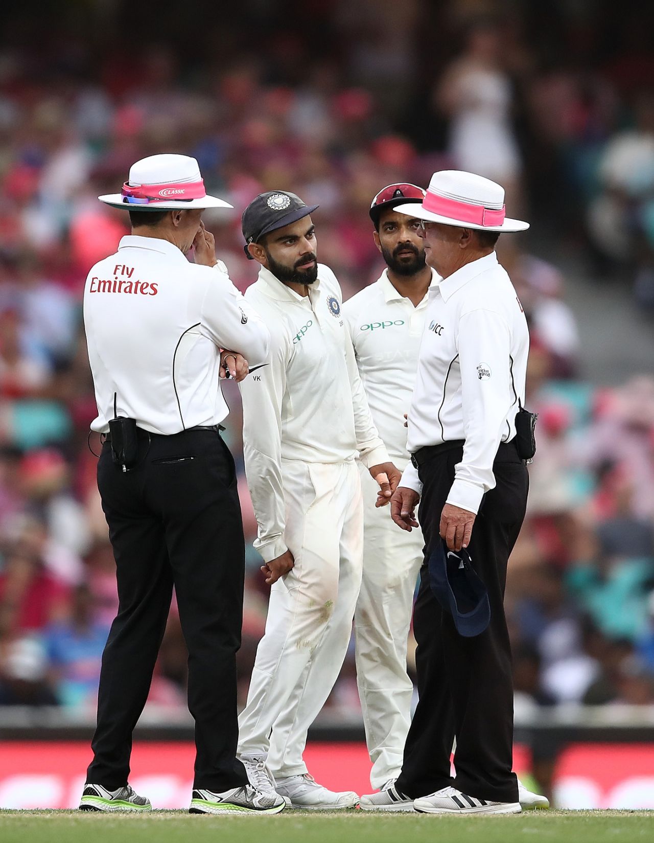 Virat Kohli and Ajinkya Rahane, the India captain and vice-captain respectively, have a chat with the on-field umpires, Australia v India, 4th Test, Sydney, 3rd day, January 5, 2019