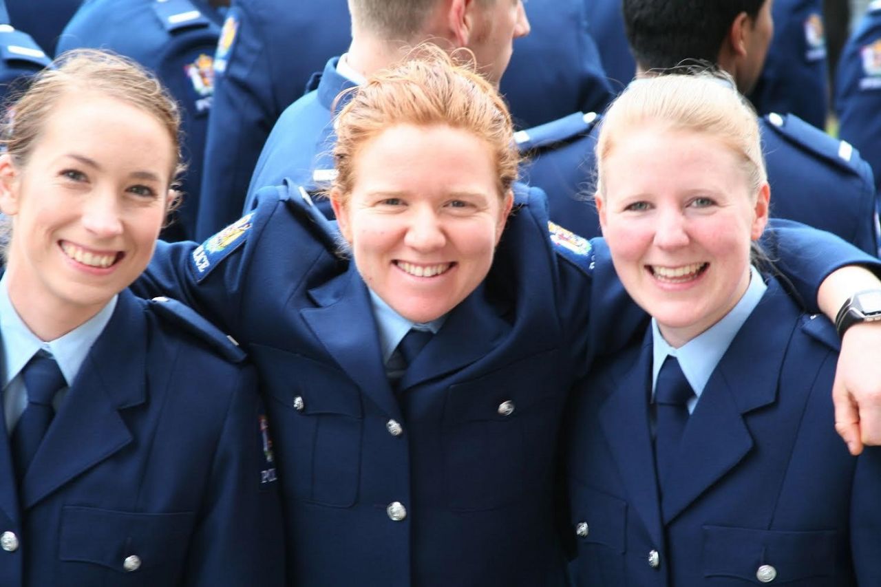 Katie Perkins (centre) served as a Youth Engagement Officer with the Auckland Police Department