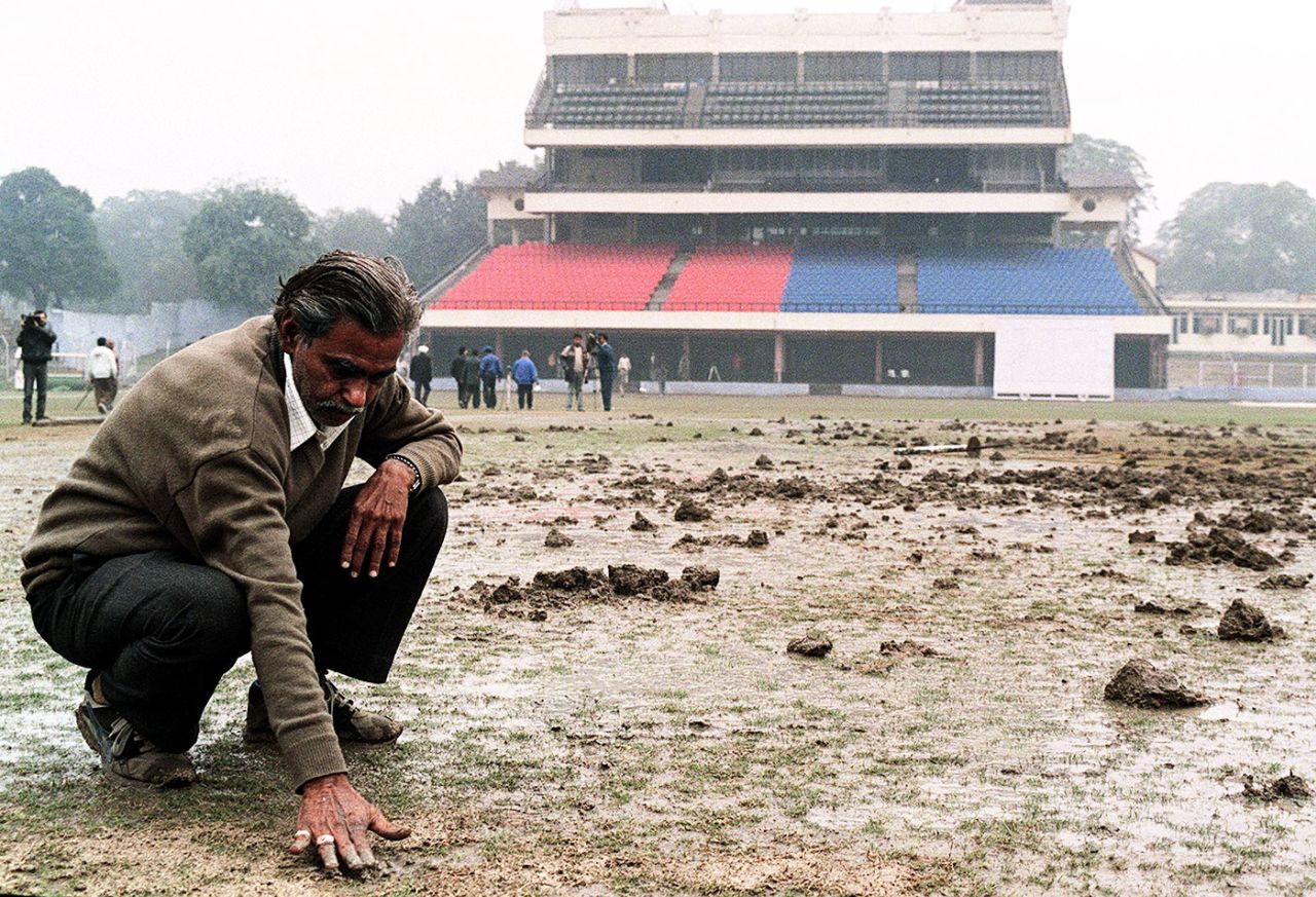 A groundsman inspects the Kotla pitch after it was dug up by protesters, Delhi, January 9, 1999