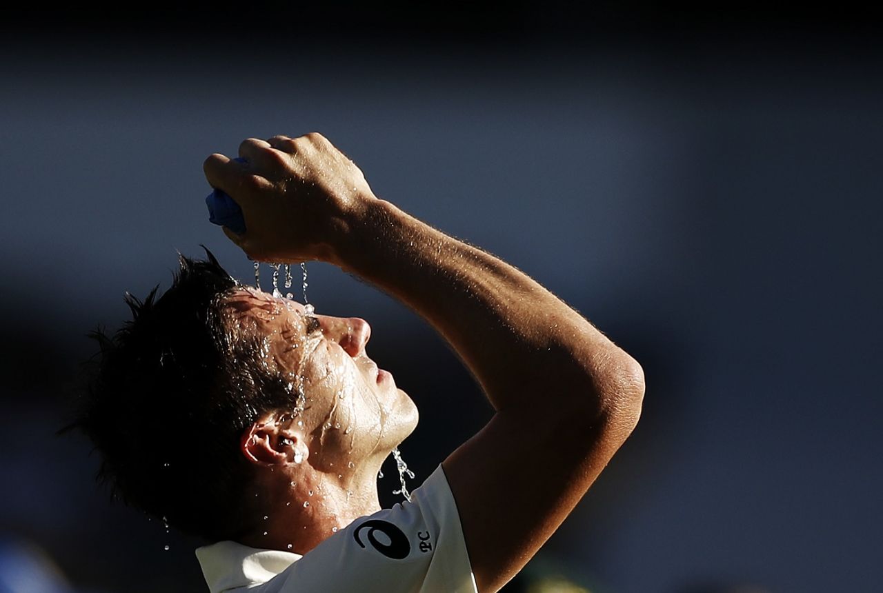 Pat Cummins cools down during a hot afternoon session. Australia v Sri Lanka, 1st Test, Brisbane, 3rd day, January 26, 2019