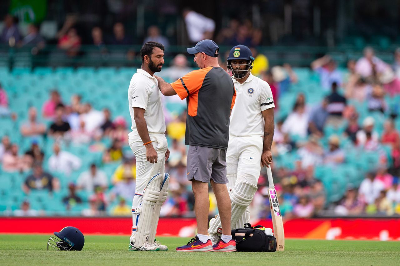Physiotherapist Patrick Farhart attends to Cheteshwar Pujara after he was hit by the ball, Australia v India, 4th Test, Sydney, 1st day, January 3, 2019