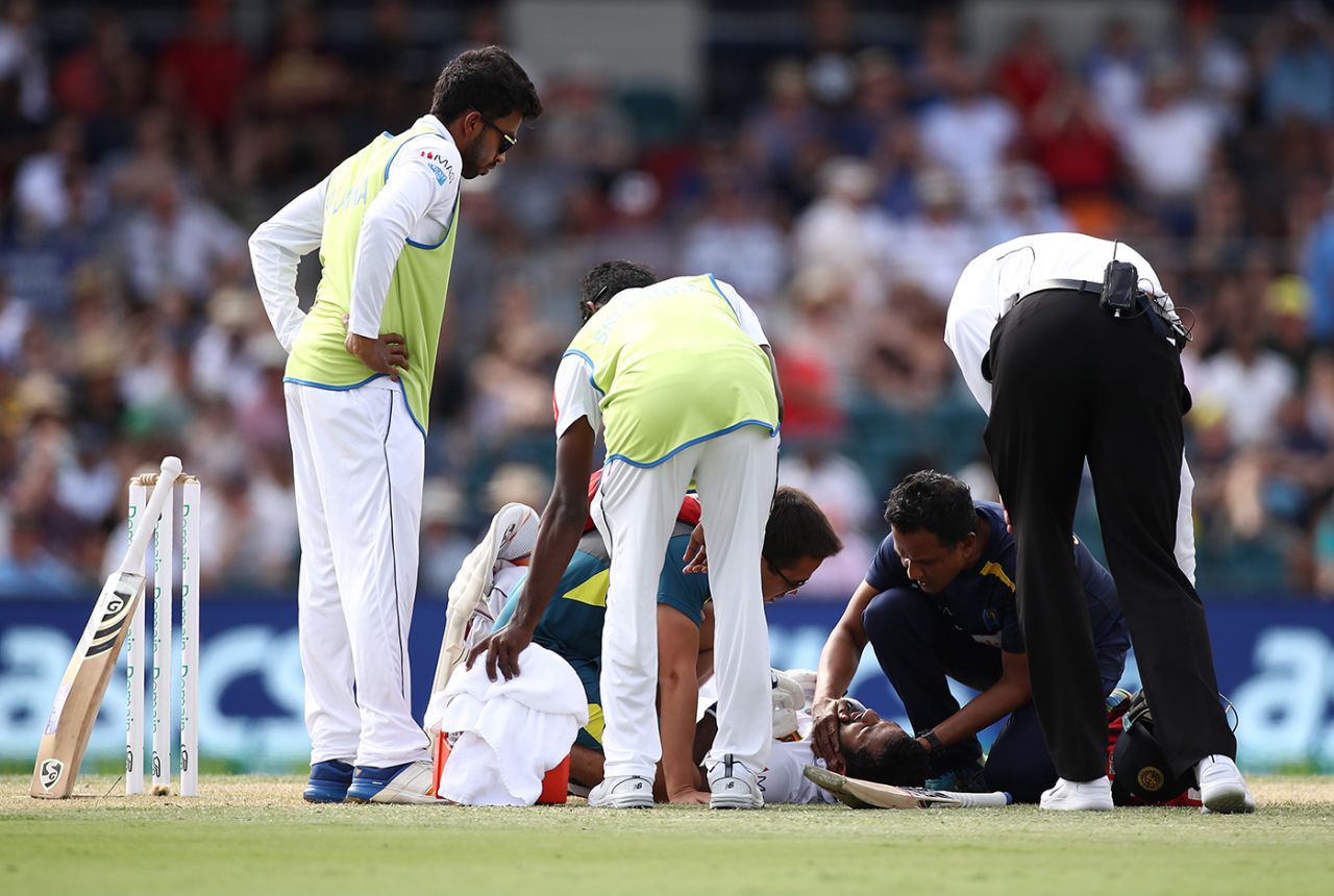 Sri Lanka's physio checks on Dimuth Karunaratne after he is hit on the head by a Pat Cummins bouncer, Australia v Sri Lanka, 2nd Test, Canberra, February 2, 2019