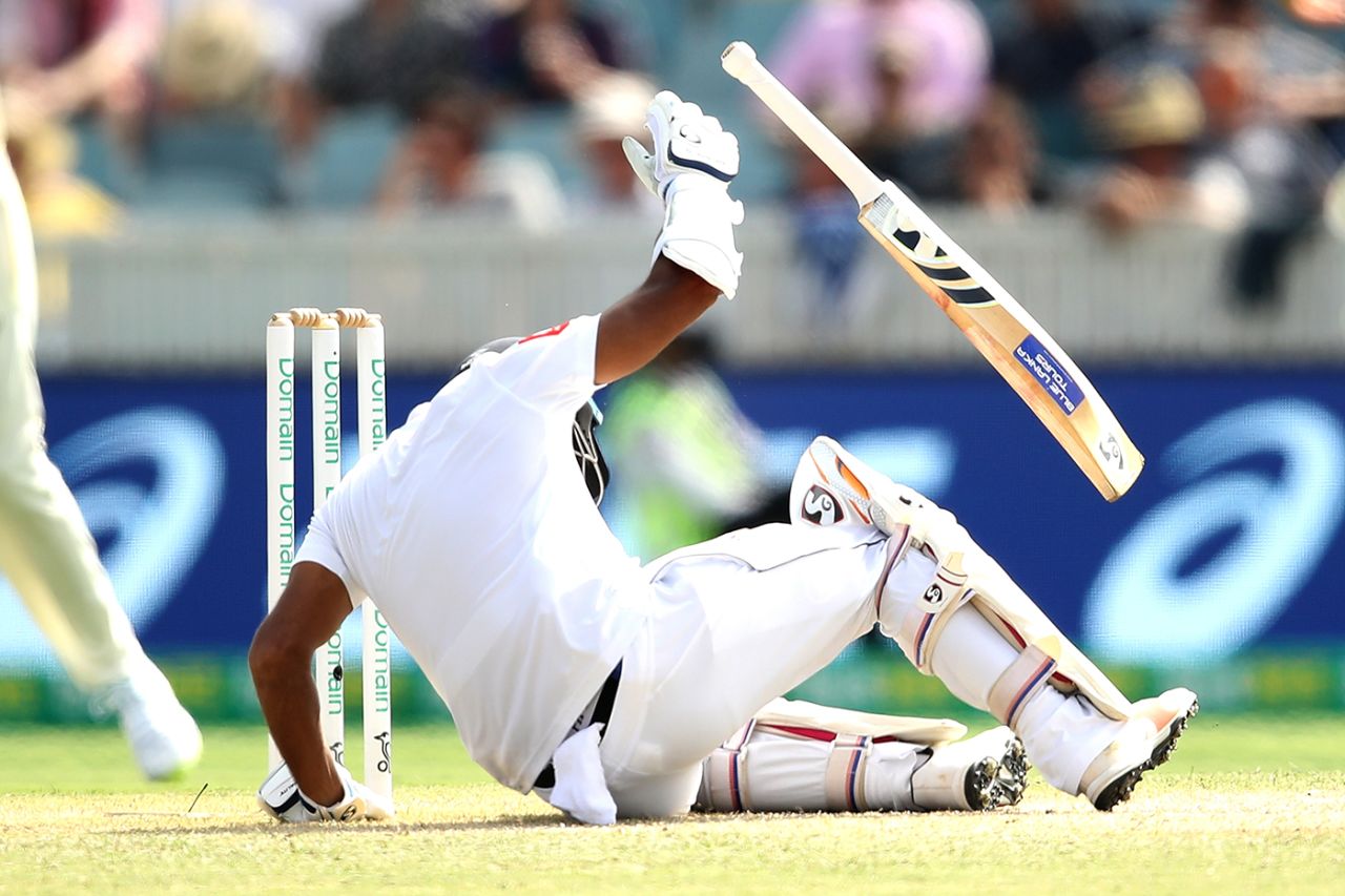Dimuth Karunaratne falls to the floor after being struck on the head by a Pat Cummins bouncer, Australia v Sri Lanka, 2nd Test, Canberra, February 2, 2019