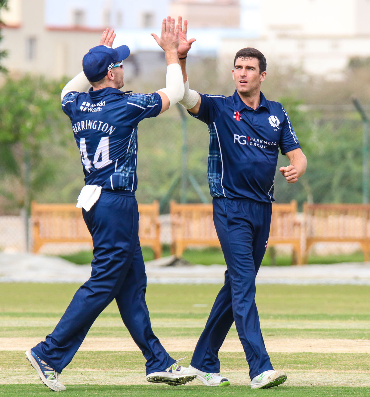 Ruaidhri Smith gets a high five after taking another wicket, Oman v Scotland, Al Amerat, February 19, 2019