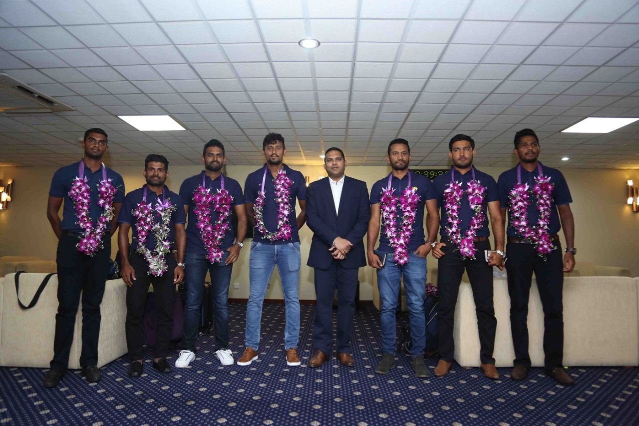 Members of Sri Lanka's squad that won the Test series in South Africa pose with Minister of Sports Harin Fernando