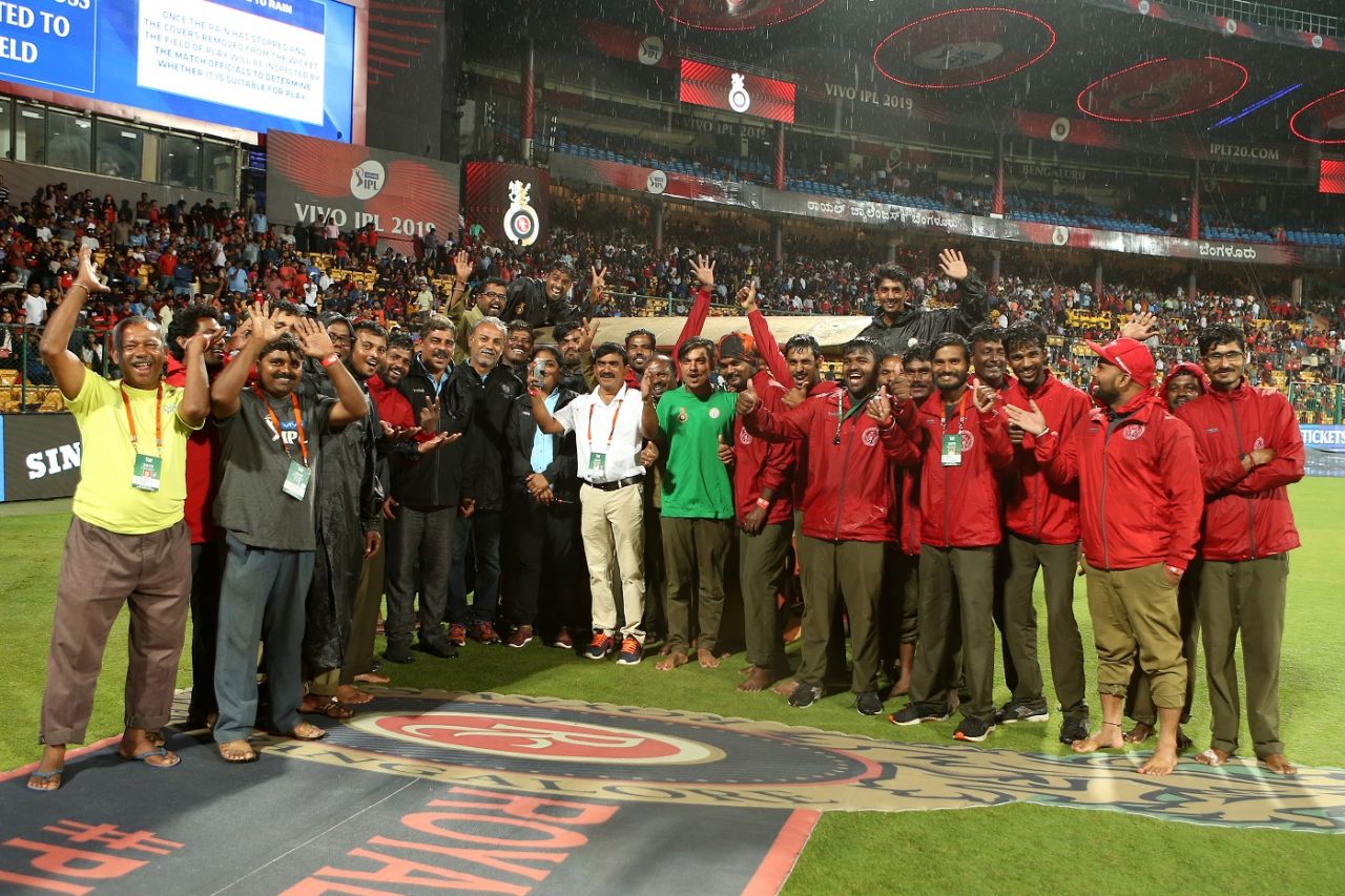 The groundstaff in Bengaluru pose for a photo while rain pounds the M Chinnaswamy Ground, Royal Challengers Bangalore v Rajasthan Royals, IPL 2019, Bengaluru, April 30, 2019