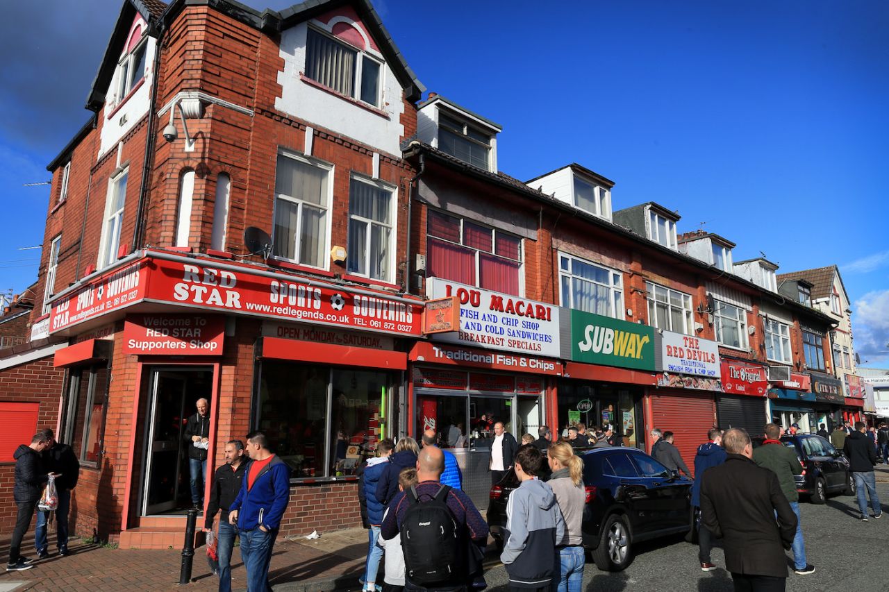 Fans mingle at the Lou Macari Fish & Chip Shop, Old Trafford, Manchester, England, October 6, 2018