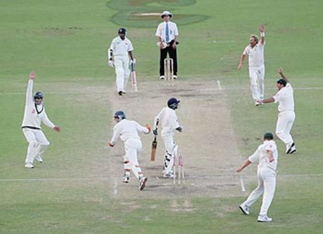 Shane Warne dismisses Upul Chandana to equal Muttiah Muralitharan's world record of 527 wickets, on the final day at Cairns, Australia v Sri Lanka, 2nd Test, Cairns, 5th day, July 13, 2004