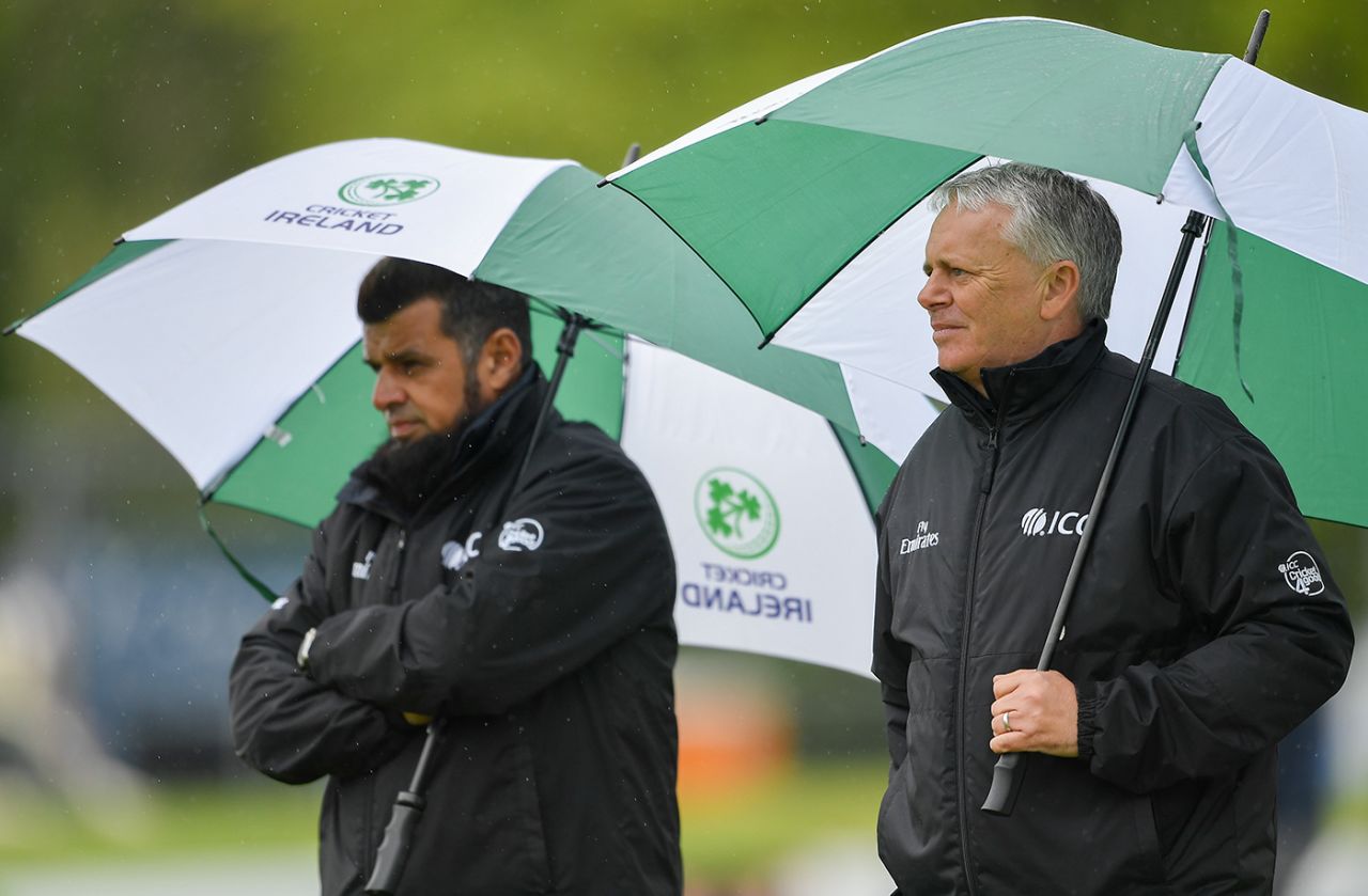 Umpires Aleem Dar and Mark Hawthorne take shelter from the rain, Ireland v Bangladesh, tri-series, Dublin, May 9, 2019