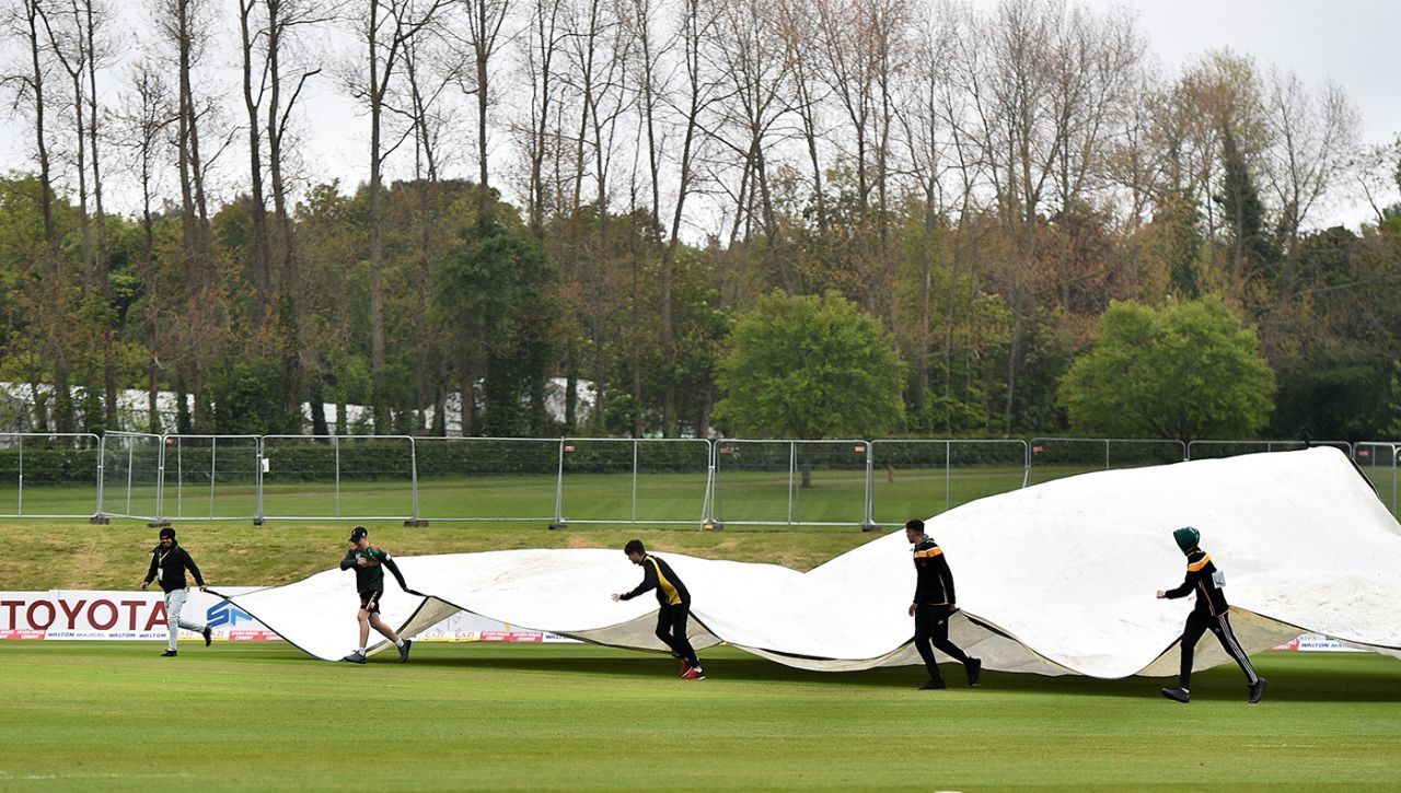 The groundstaff rush covers onto the field, West Indies v Bangladesh, tri-nation series final, Malahide, May 17, 2019