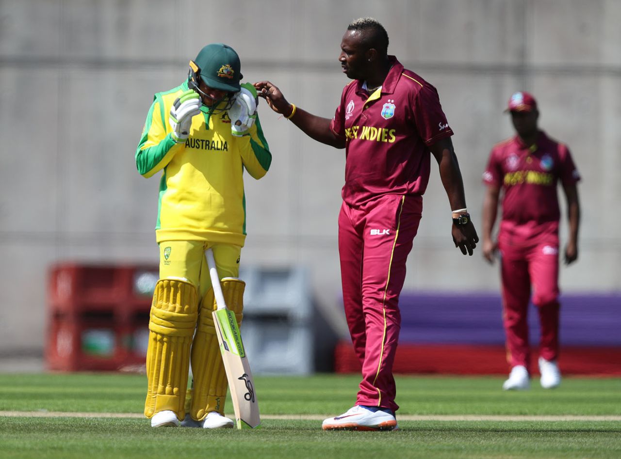 Andre Russell checks on Usman Khawaja after hitting him on the head with a bouncer during a World Cup warm-up match at the Nursery Ground, Southampton, May 22, 2019