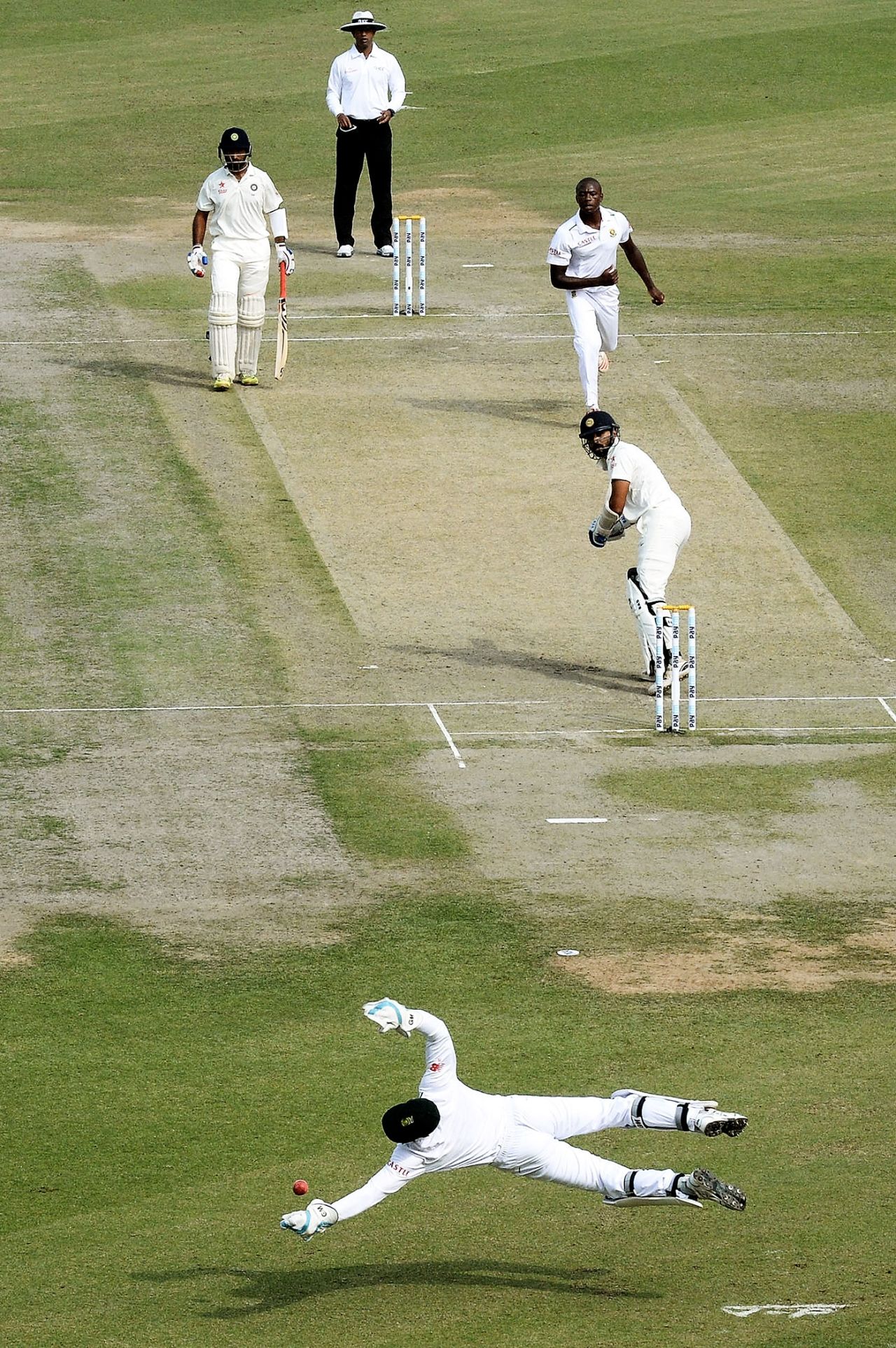 Kagiso Rabada looks on as Dane Vilas tries to stop a shot from M Vijay, India v South Africa, 1st Test, Mohali, 1st day, November 5, 2015