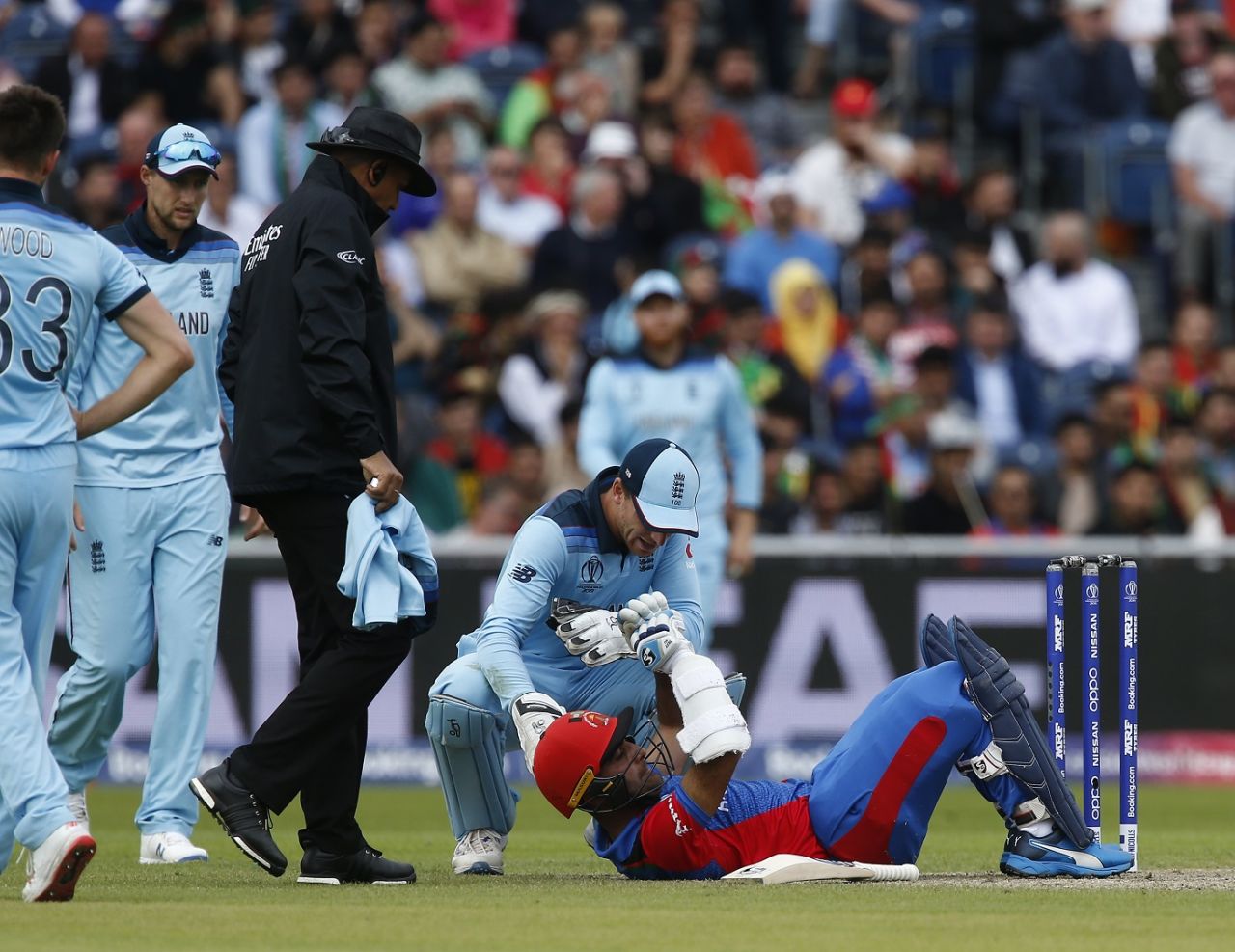 Jos Buttler checks on Hashmatullah Shahidi after he is struck by a Mark Wood bouncer, England v Afghanistan, World Cup 2019, Manchester, June 18, 2019