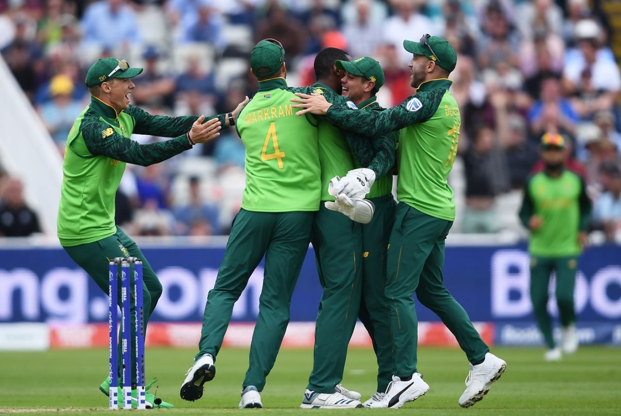 Kagiso Rabada is embraced by his teammates as they celebrate the wicket of Colin Munro, South Africa v New Zealand, World Cup 2019, Birmingham, June 19, 2019