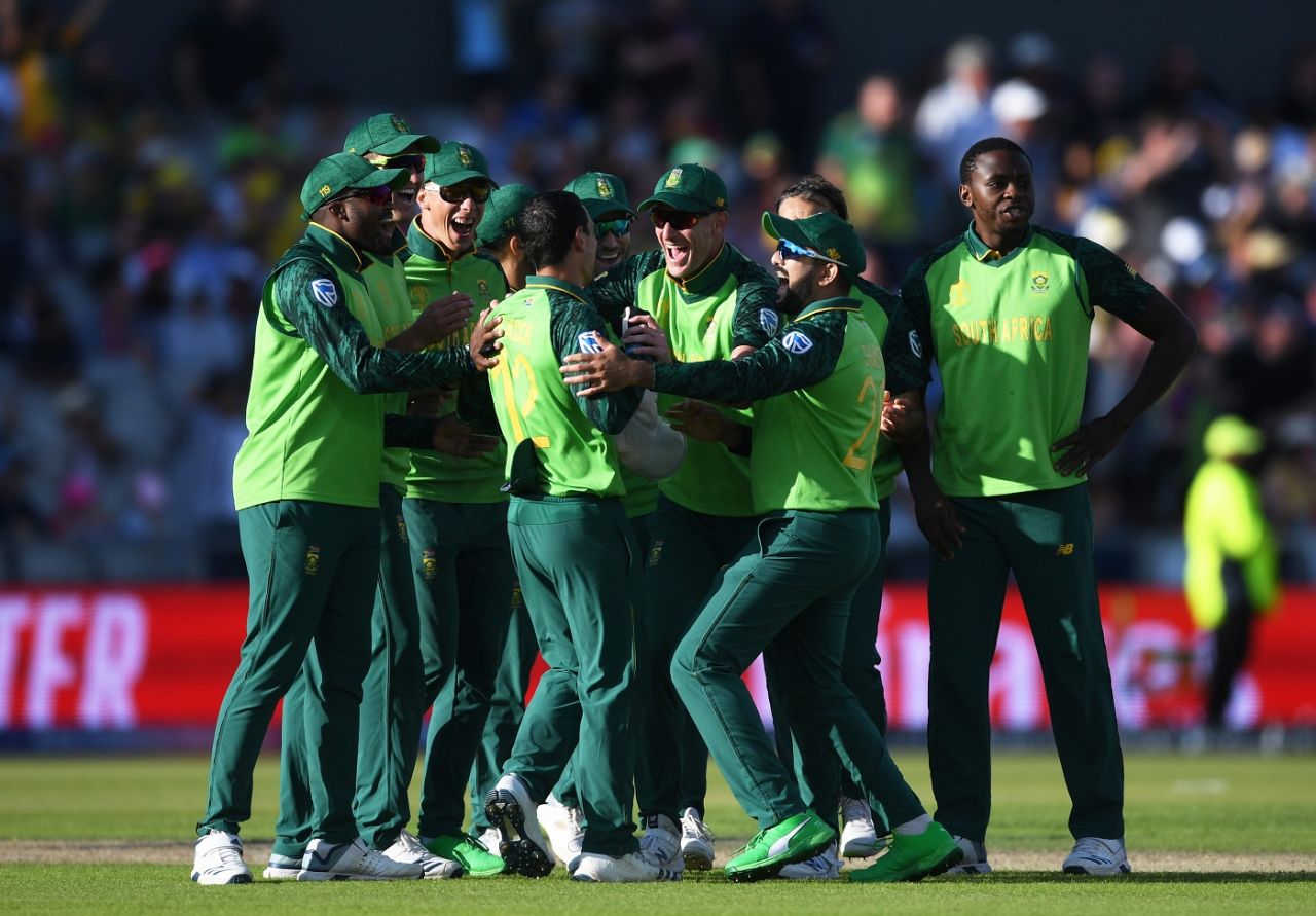 Quinton de Kock is mobbed by teammates after pulling off a stunning run-out 