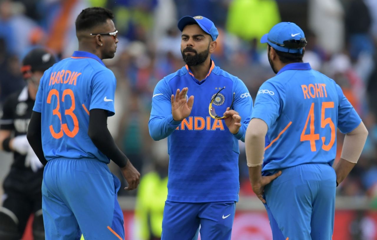 Hardik Pandya, seen here in discussion with Virat Kohli and Rohit Sharma, limped off with an injury after the 16th over, India v New Zealand, World Cup 2019, Old Trafford, July 9, 2019