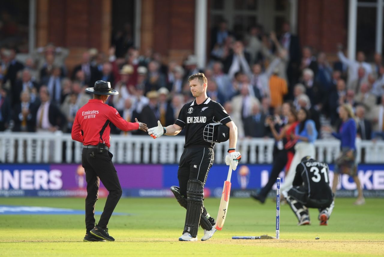 Umpire Kumar Dharmasena shakes hands with Jimmy Neesham even as Martin Guptill is on his haunches in the background, England v New Zealand, World Cup 2019, Lord's, July 14, 2019