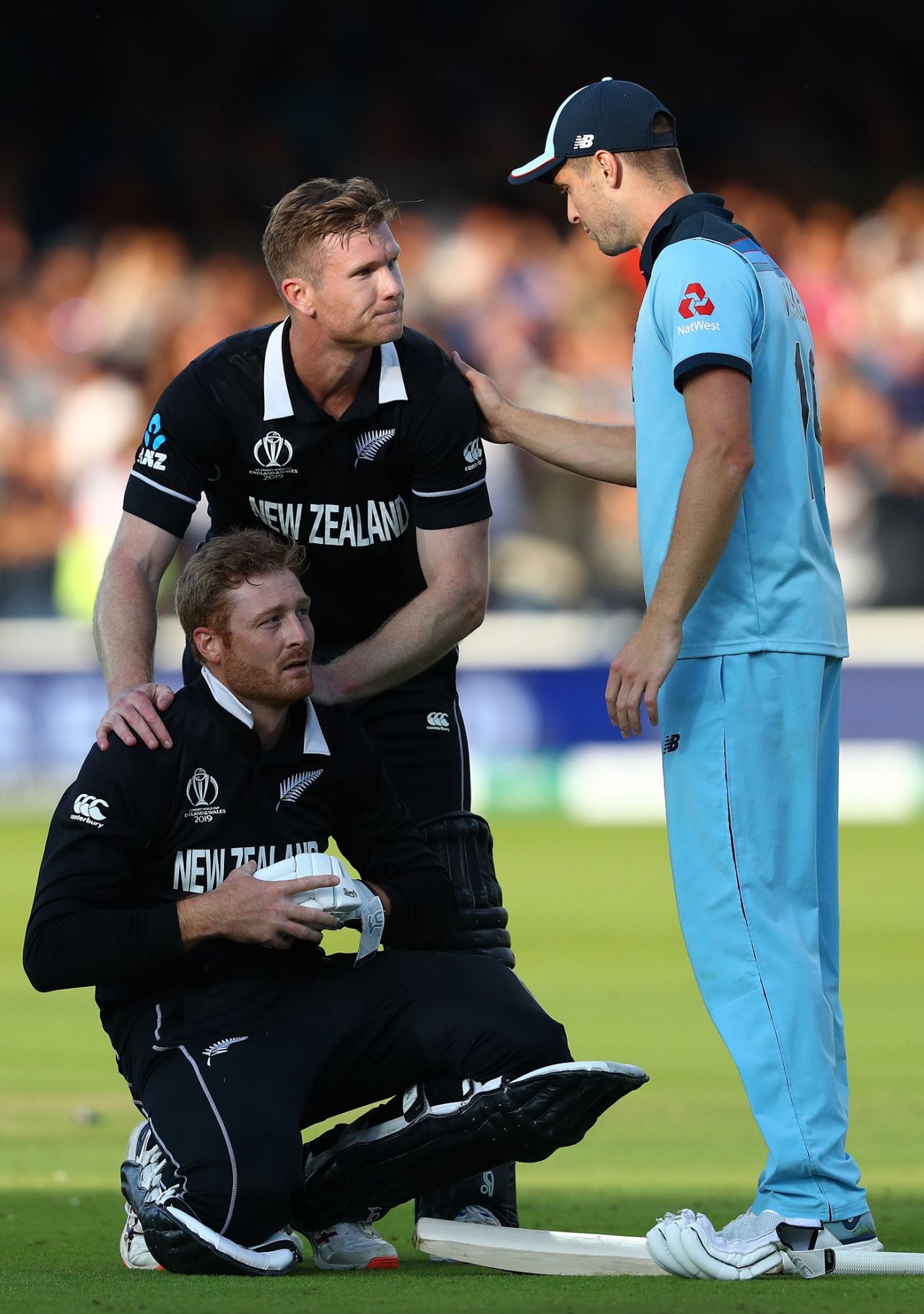 Chris Woakes consoles Jimmy Neesham and Martin Guptill after England sealed a thrilling Super Over, England v New Zealand, World Cup 2019 final, Lord's, July 14, 2019