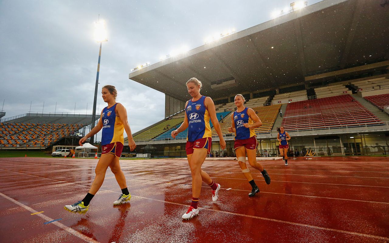 Delissa Kimmince (centre) walks out to train with some of her Brisbane Lions AFL Women's team-mates, Brisbane, Australia, March 22, 2017