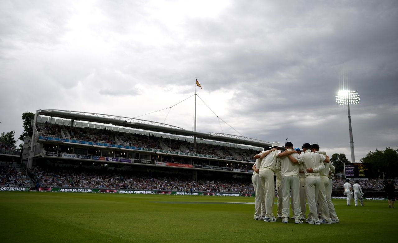 England get together in a team huddle under a gloomy sky, England v Ireland, only Test, Lord's, 3rd day, July 26, 2019