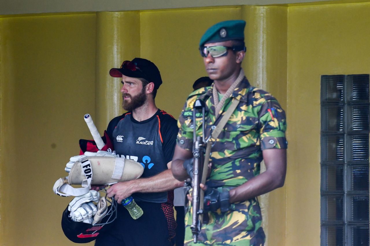 A solider stands guard as Kane Williamson walks out to train, Colombo, August 20, 2019