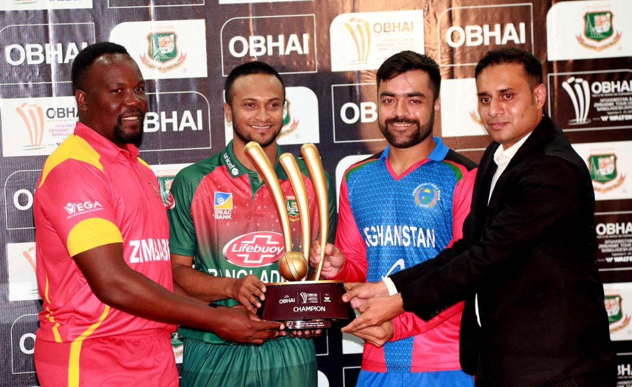 Hamilton Masakadza, Shakib Al Hasan and Rashid Khan pose with the T20I trophy, September 12, 2019