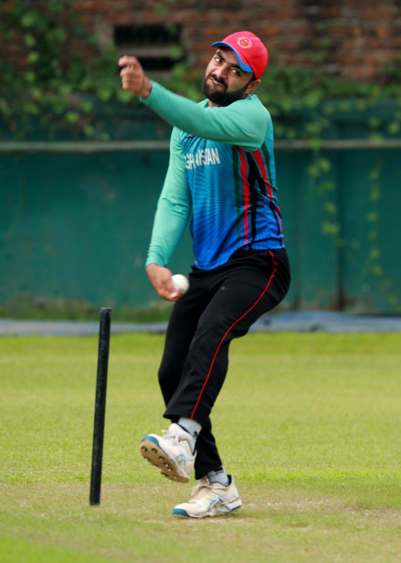 Rashid Khan grimaces while bowling in the nets on the eve of the final, Dhaka, September 23, 2019