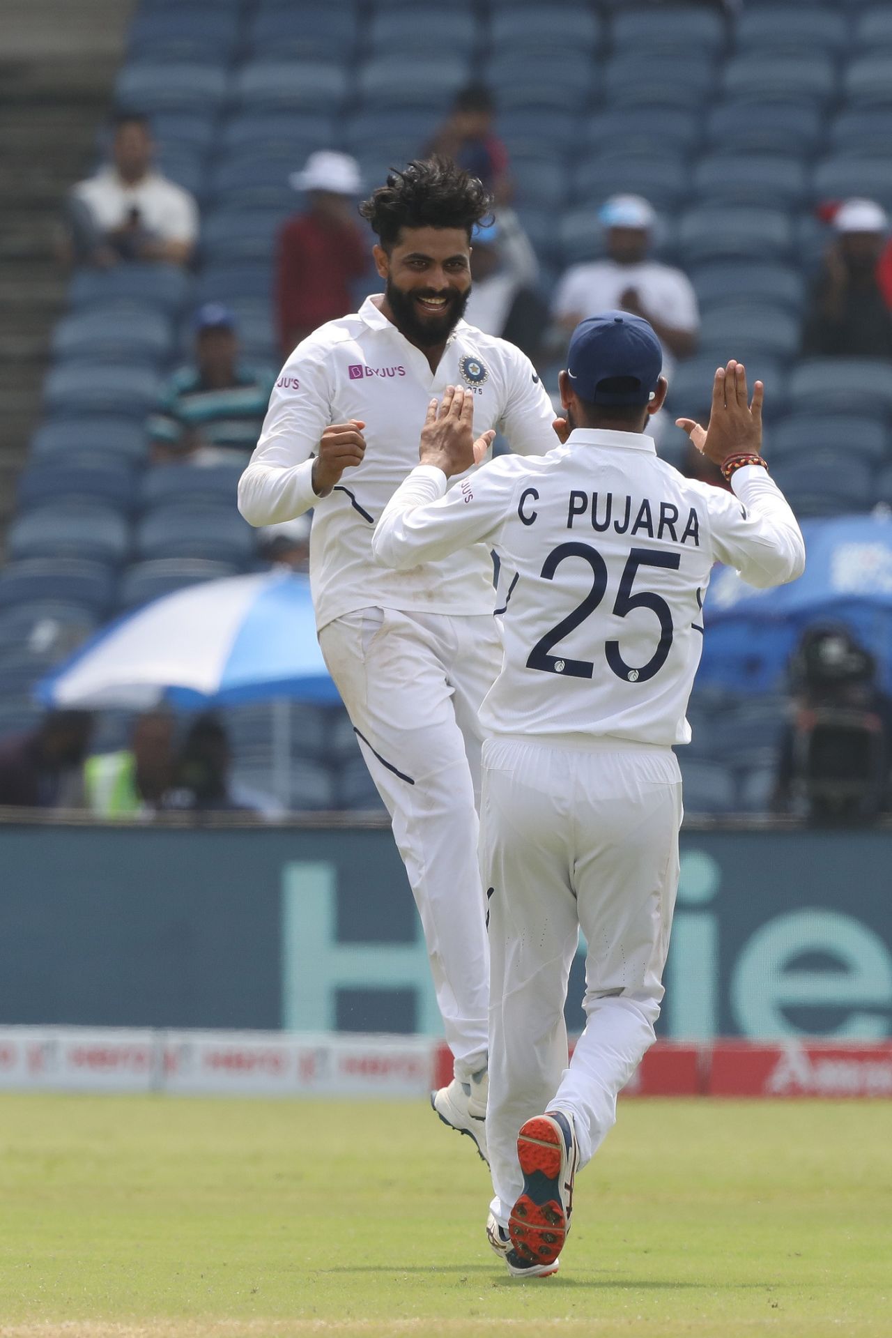 Ravindra Jadeja celebrates a wicket with Cheteshwar Pujara, India v South Africa, 2nd Test, Pune, 4th day, October 13, 2019