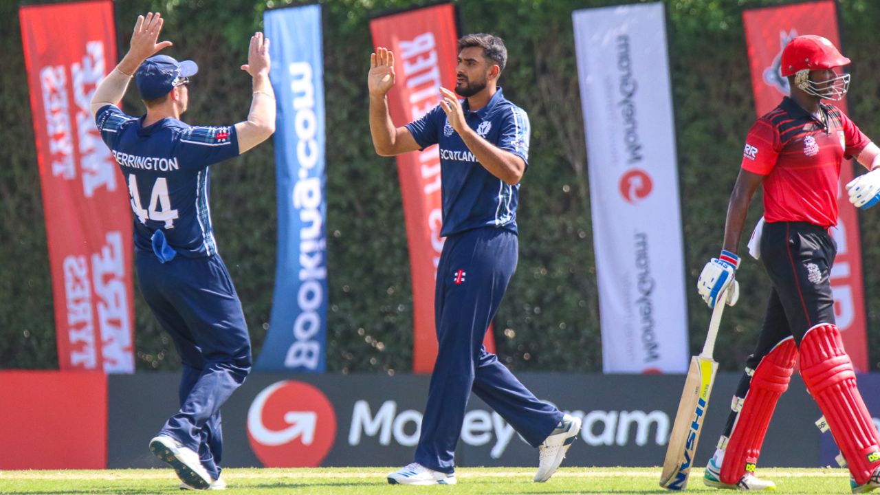 Safyaan Sharif gets a high five after bowling Surendran Chandramohan for 51, Scotland v Singapore, T20 World Cup Qualifier, Dubai, October 18, 2019