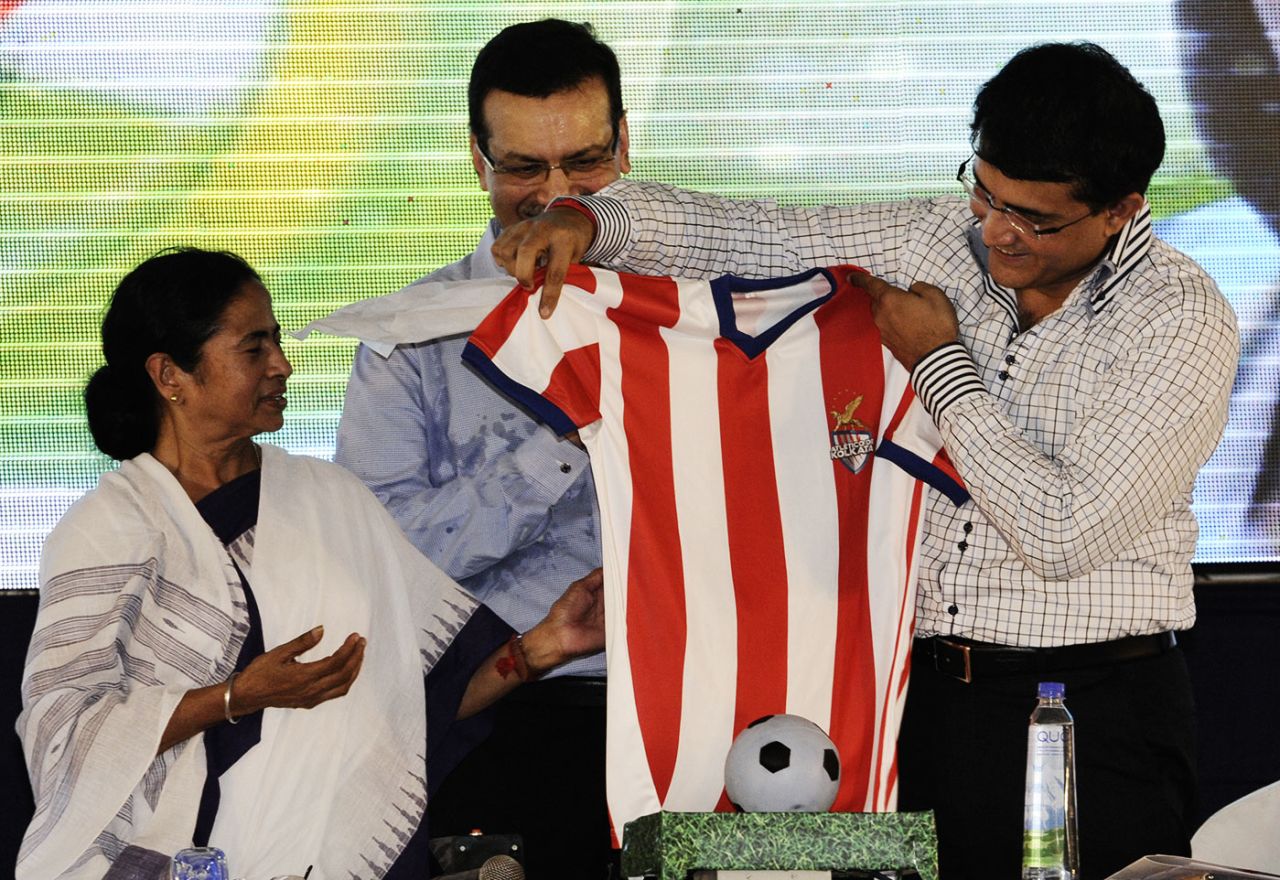 West Bengal's chief minister Mamata Bannerjee unveils Atletico Kolkata's jersey along with the franchise's co-owner Sourav Ganguly, July 7, 2014