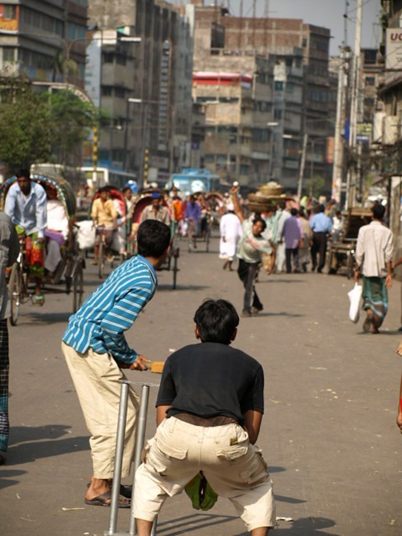 Ashik Mahmud: The world might pass you by, but nothing's more important than the cricket. A street scene from Dhaka