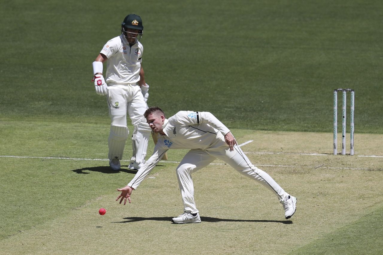 Lockie Ferguson picks up a ball on his followthrough, Australia v New Zealand, 1st Test, Perth, 1st day, December 12, 2019