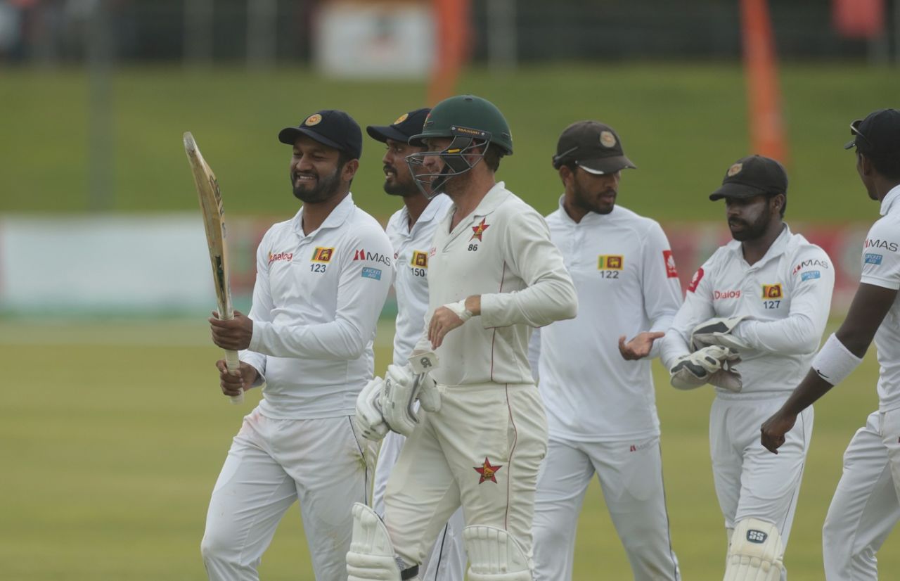 Dimuth Karunaratne checks Sean Williams' bat as the players walk off, Zimbabwe v Sri Lanka, 2nd Test, Harare, 4th day, January 30, 2020