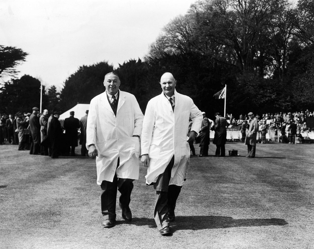 Umpires Maurice Tate and John Langridge (right) walk out for a game in 1956