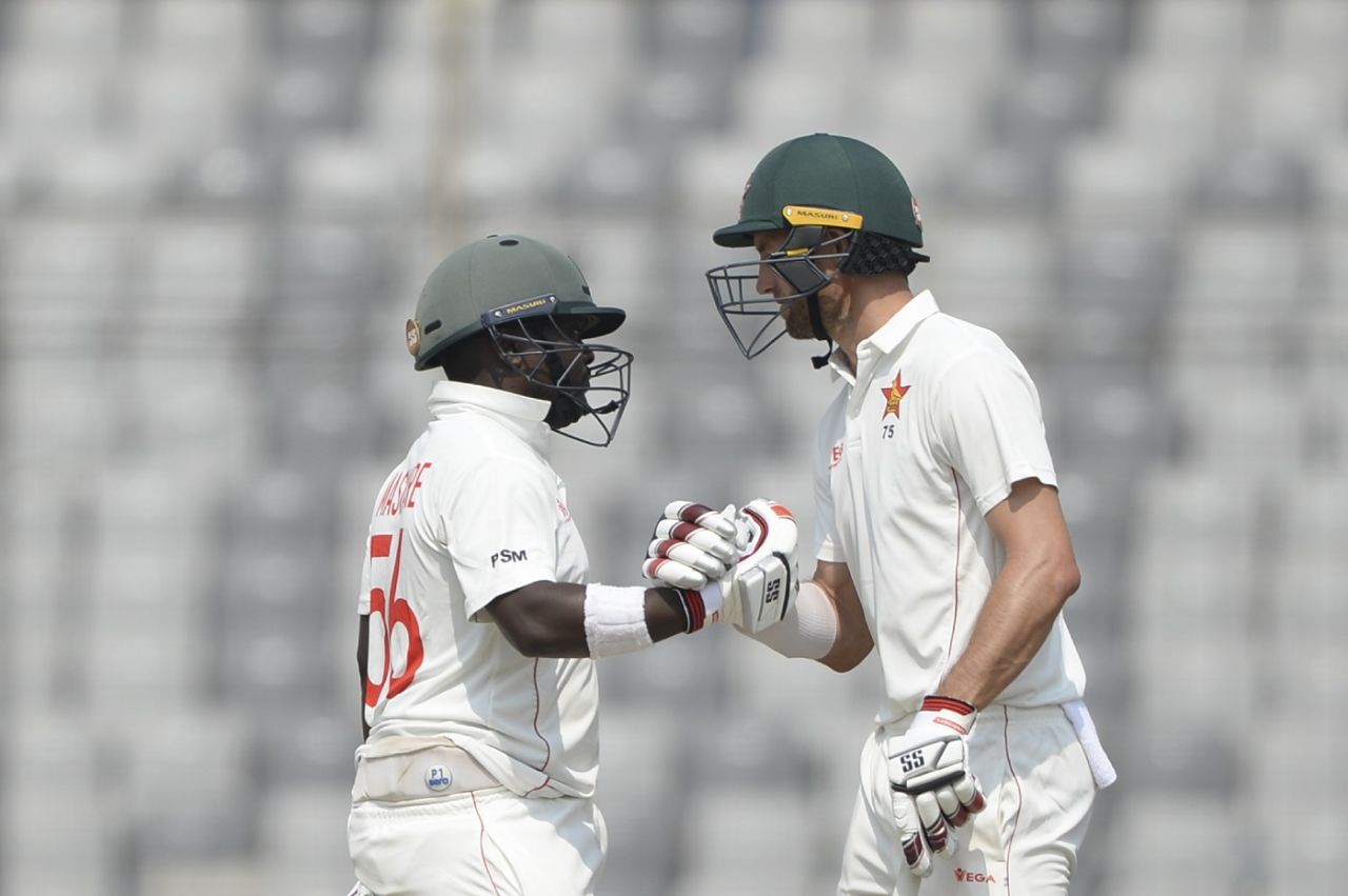 Prince Masvaure punches gloves with Craig Ervine after bringing up a landmark, Bangladesh v Zimbabwe, Only Test, Dhaka, 1st day, February 22, 2020