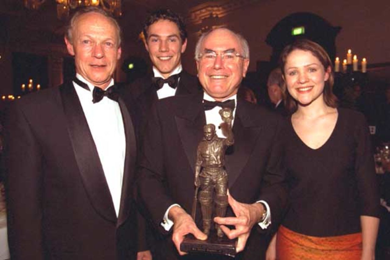 17 Aug 2000: (l-r) John Bradman, son of Sir Donald, Tom Bradman, Grandson of Sir Donald, Australian Prime Minister John Howard and Greta Bradman, Grand daughter of Sir Donald, with a statue presented to John Howard at the Sir Donald Bradman Oration held in Melbourne, Australia.