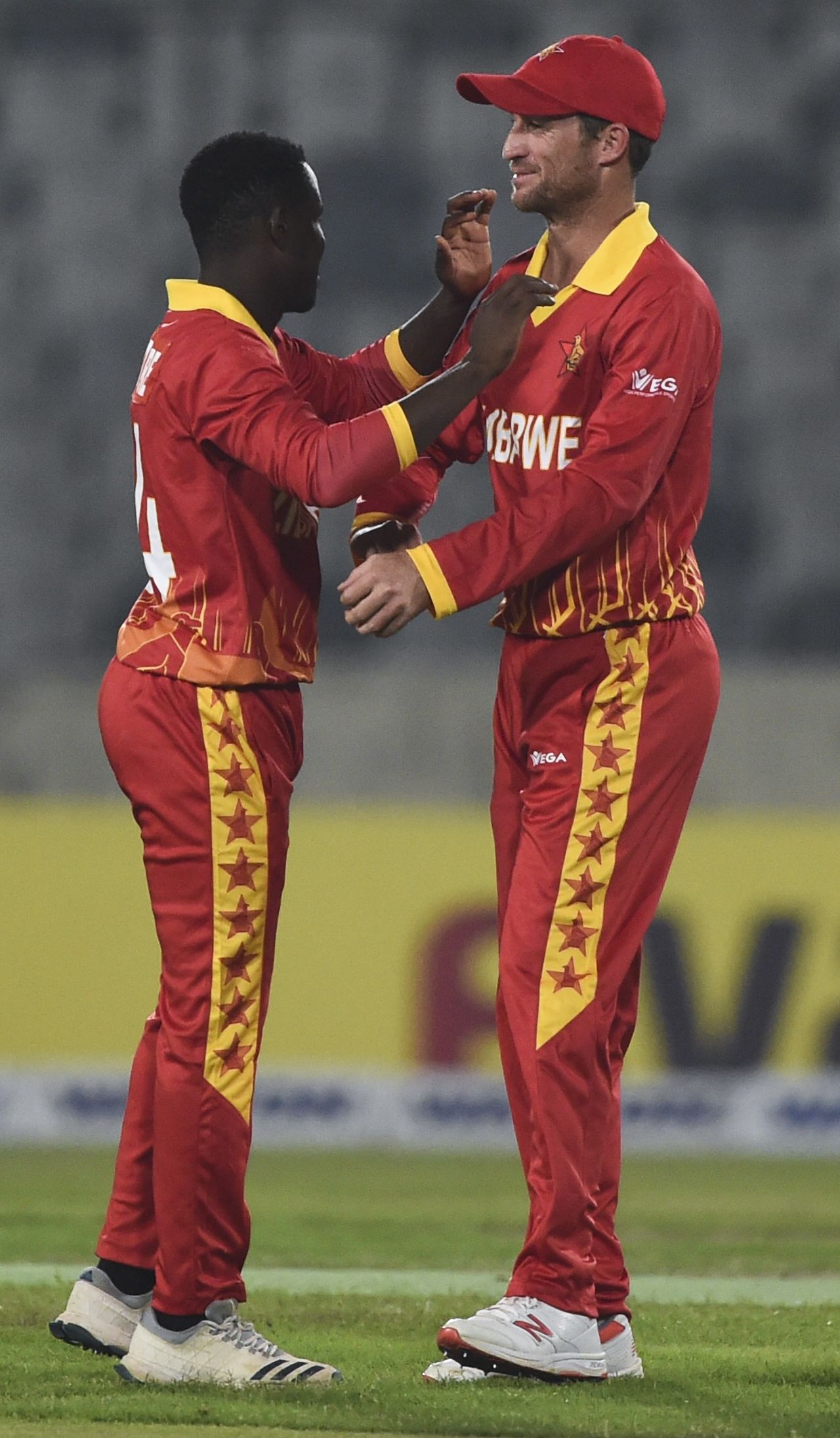 Wesley Madhevere celebrates with Sean Williams, Bangladesh v Zimbabwe, 1st T20I, Dhaka, March 9, 2020