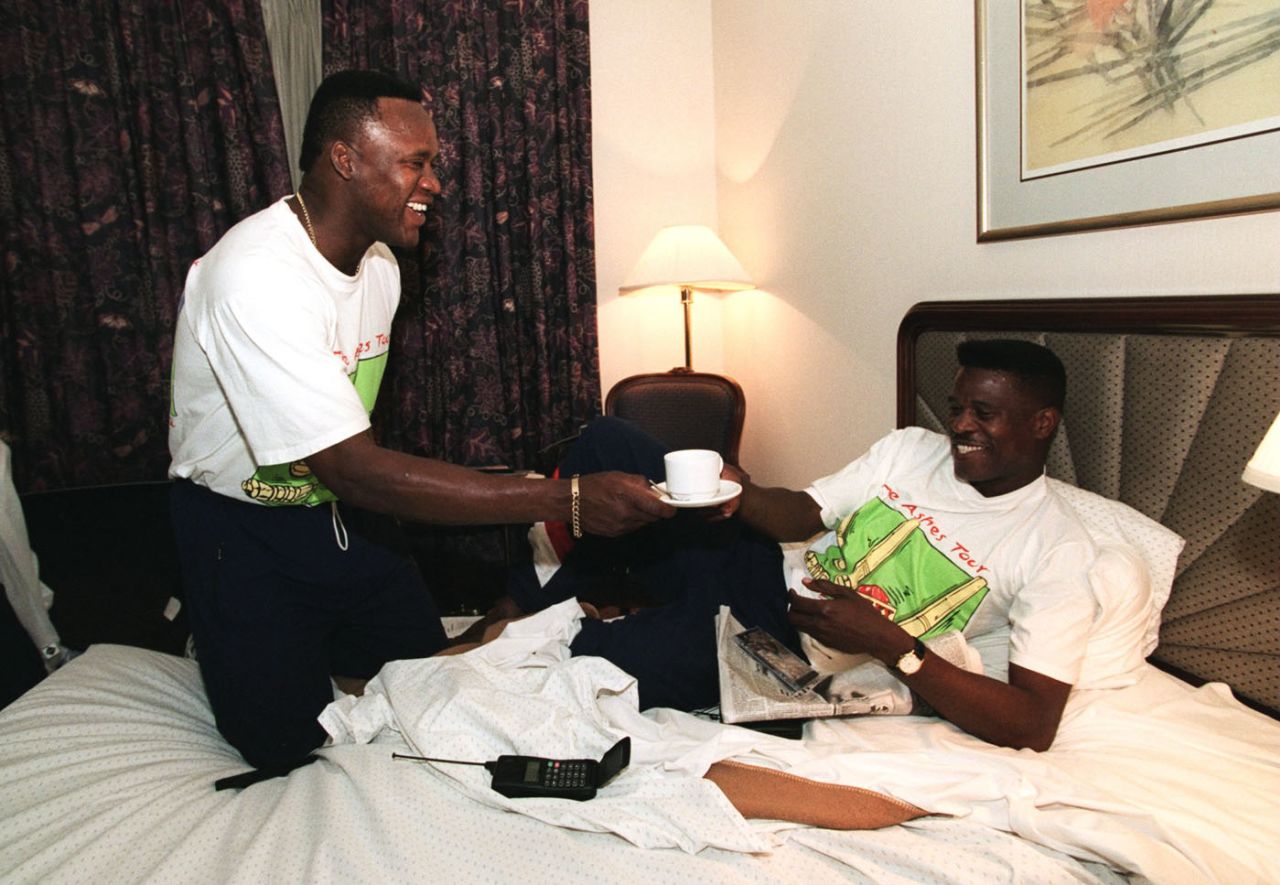 Devon Malcolm offers a cup of tea to his chicken-pox-afflicted team-mate Joey Benjamin in his hotel room, Sydney, December 9, 1994