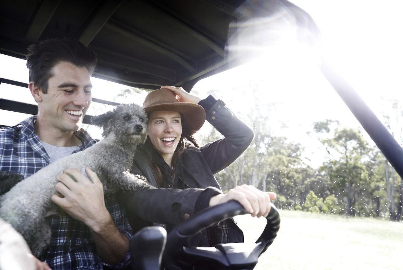 Pat Cummins, his fiancé Becky Boston and their dog Norman ride on their farm buggy while in isolation, Southern Highlands, New South Wales, Australia, April 13, 2020